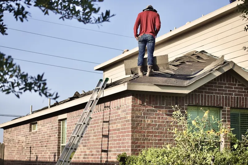 Professional roofer working on a residential roof in Conant